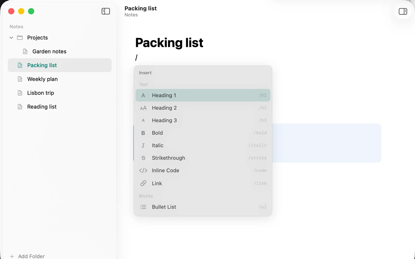 The slash menu open under the cursor, listing headings, bold, italic and more